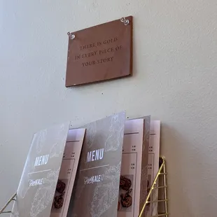 menus and a sign on the wall