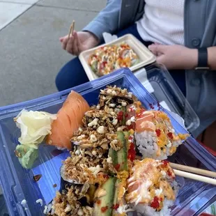 a woman eating sushi with chopsticks