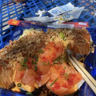 sushi with chopsticks in plastic container