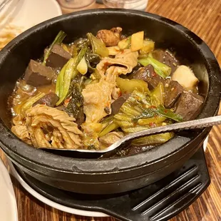 a pot of food with a spoon in it