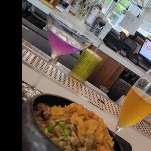 a bowl of rice and a glass of beer