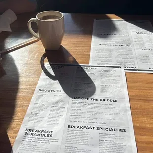 two cups of coffee and a menu
