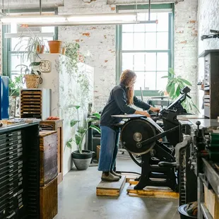 Lindsay, letterpress artist &amp; owner printing on her antique Chandler &amp; Price Printing Press in her Lawrenceville studio.