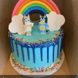 a cake with a rainbow on top