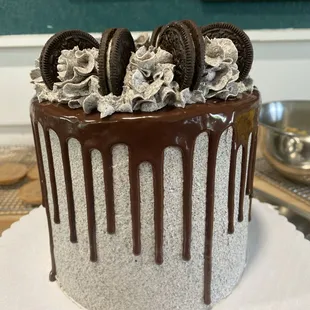 a frosted cake with oreo cookies on top