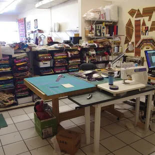 The work area...always a bit chaotic, with two sewing machines and a few thousand yards of fabric...