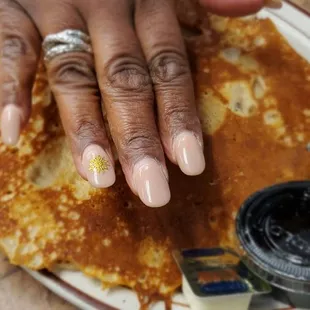 a plate of pancakes with butter and syrup