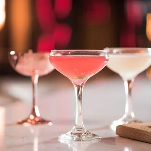 three cocktail glasses on a table