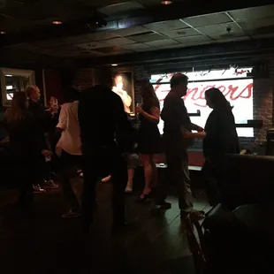 a group of people in a dimly lit room