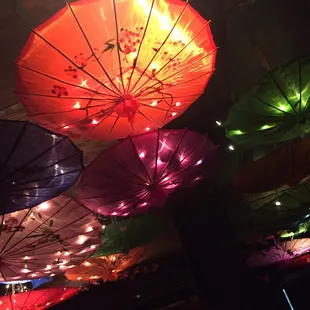 brightly lit umbrellas hanging from the ceiling