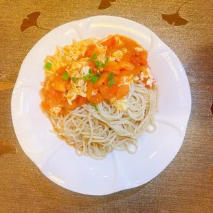 Chengdu style stir fried noodles topped with diced tomatoes and scrambled eggs