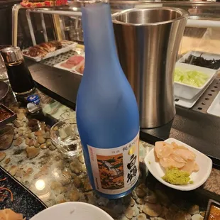a bottle of ginko sake and a plate of rice
