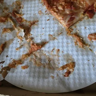 Cheese stuck to the paper below the crust