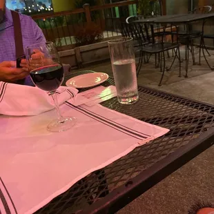 a man sitting at a table with a glass of wine