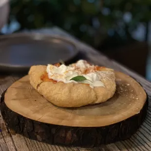 a pizza on a wooden board