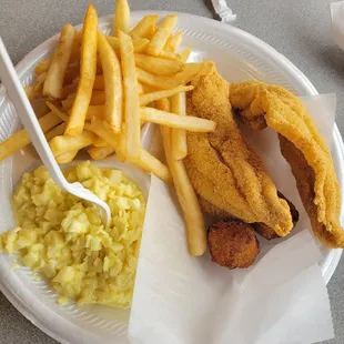 Fried catfish played with two hush puppies, coleslaw, French fries.