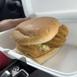 a chicken sandwich in a styrofoam container