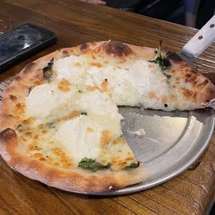 a pizza with cheese and spinach