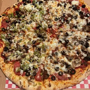 Ground beef, bell pepper, pepperoni, onion, mushroom and olive pizza