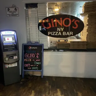 a sign for gino&apos;s pizza bar