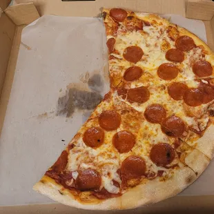 a half eaten pepperoni pizza
