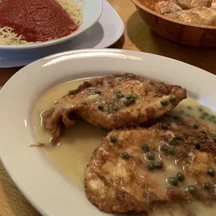 Chicken Francese, angel hair with tomato sauce &amp; garlic knots.