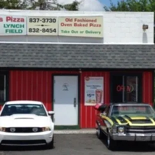 cars parked in front of a restaurant