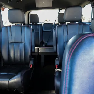 Comfortable, leather seating with two TVs for entertainment.