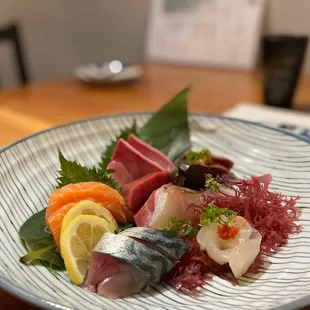 a plate of sushi and sashimi