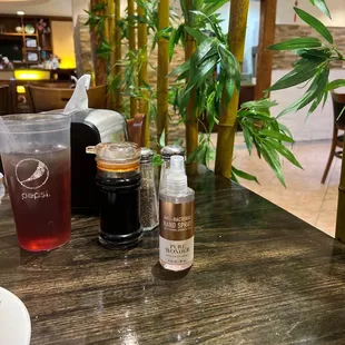 a table with drinks and condiments