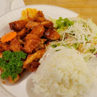 Spicy chicken (crispy) with white rice and a side salad. Really good with an extra kick of Sriracha.