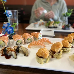 a plate of sushi and rolls