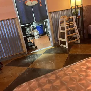 Meat on a bucket near a trash can.