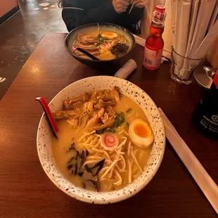 Black bowl is pork belly cashu in chicken soup. White bowl grilled chicken with Tonkatsu soup. Strawberry Ramune Drink.