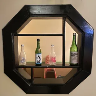a window with bottles of ginza on it