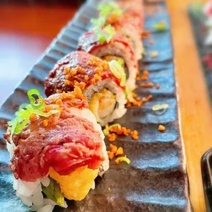 Surf &amp; Turf Roll $15.99 rib-eye steak, shrimp tempura, asparagus and garlic chips.