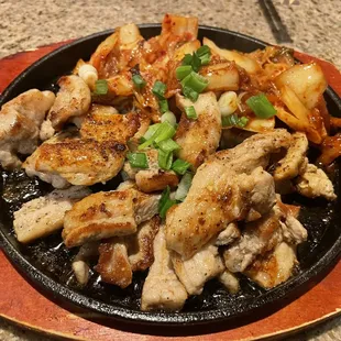 chicken and potatoes in a skillet