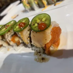 a sushi roll with jalapenos