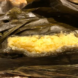 a piece of food wrapped in a banana leaf