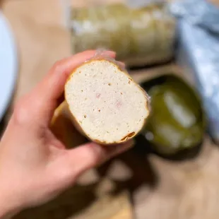 a person holding a piece of bread