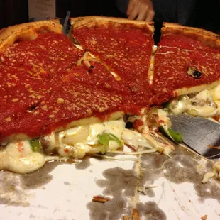 Deep dish pizza stuffed with pepperoni, bell peppers, onions, seasonings and lots of yummy, gooey cheese !