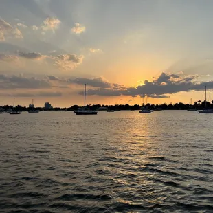 the sun setting over the water
