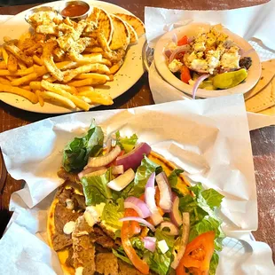 Front- the delicious lamb gyro ordered with Greek salad ( upper right) instead of fries and calamari comes w/ fries &amp; pita. Yummy