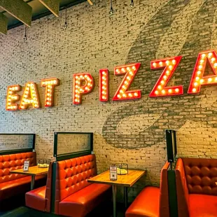 a brick wall with neon letters