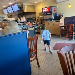 a little boy walking through the restaurant