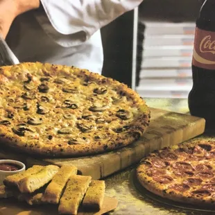 a man cutting a pizza