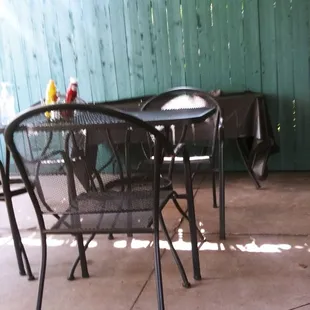 a patio with a table and chairs