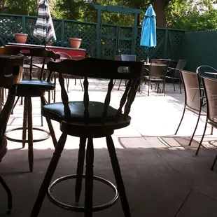 a patio with tables and chairs