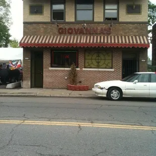 a white car parked in front of it
