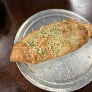 a piece of pizza on a plate